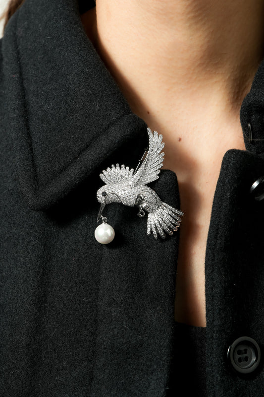 Pave Hummingbird Pearl Brooch | Silver Tone CZ Pave Flying Bird Pin with Black Stone Eye and Dangling Pearl | Elegant Nature Inspired Statement Brooch for Sarees and Formal Wear