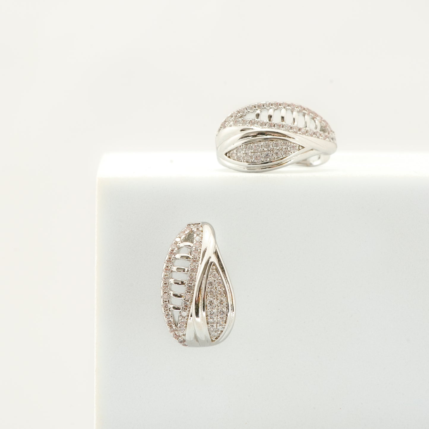 Contemporary Silver-Plated Textured Hoop-Style Earrings with Intricate Cut-Out Detailing and Diamond-Like Pave Accents for Timeless Elegance