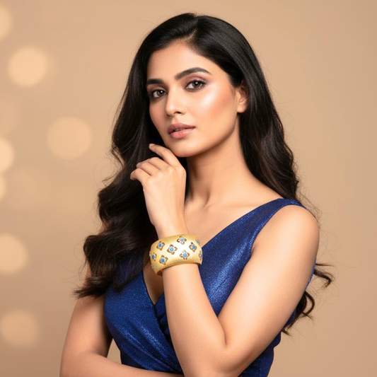 Wide Gold Cuff Bracelet with Intricate Blue Stone Floral Motifs and Satin Finish | Regal Statement Jewelry for Weddings, Festivals, and Special Occasions