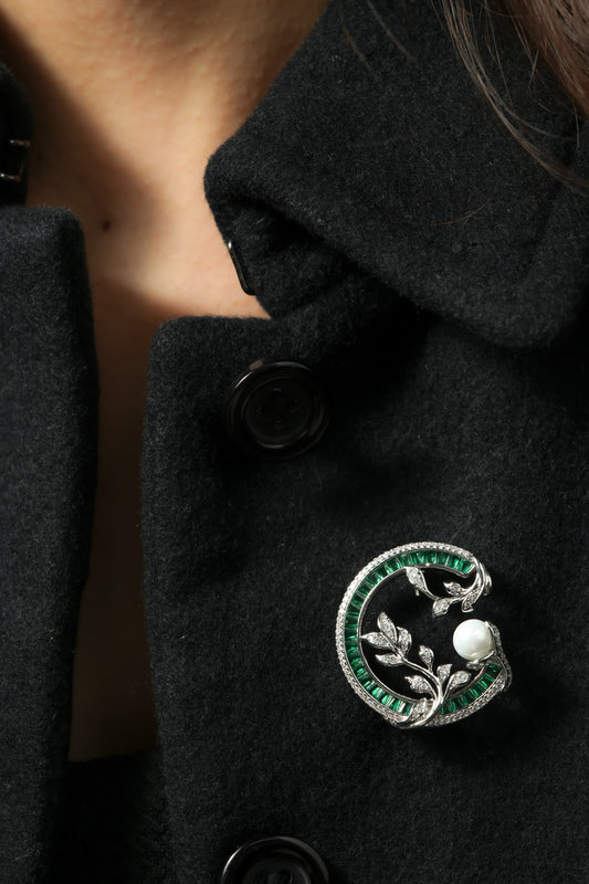 Emerald Wreath and Pearl Brooch | Silver Tone Circular Garland Brooch with Emerald Coloured Channel Set Stones, Pave CZ Leaves and Pearl Accent | Elegant Festive and Bridal Statement Pin