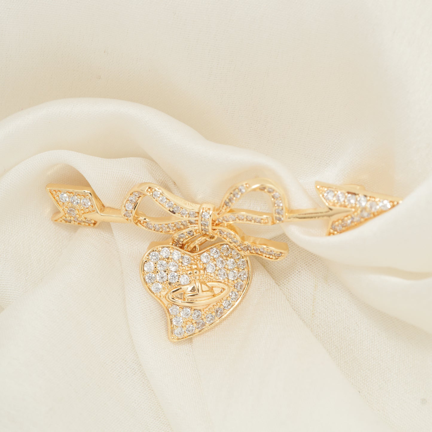 Cupid’s Bow & Heart Brooch | Gold-Tone Pave Arrow Pin with Dangling Heart Charm, Bow Accent & Clear CZ Stones | Romantic Statement Brooch