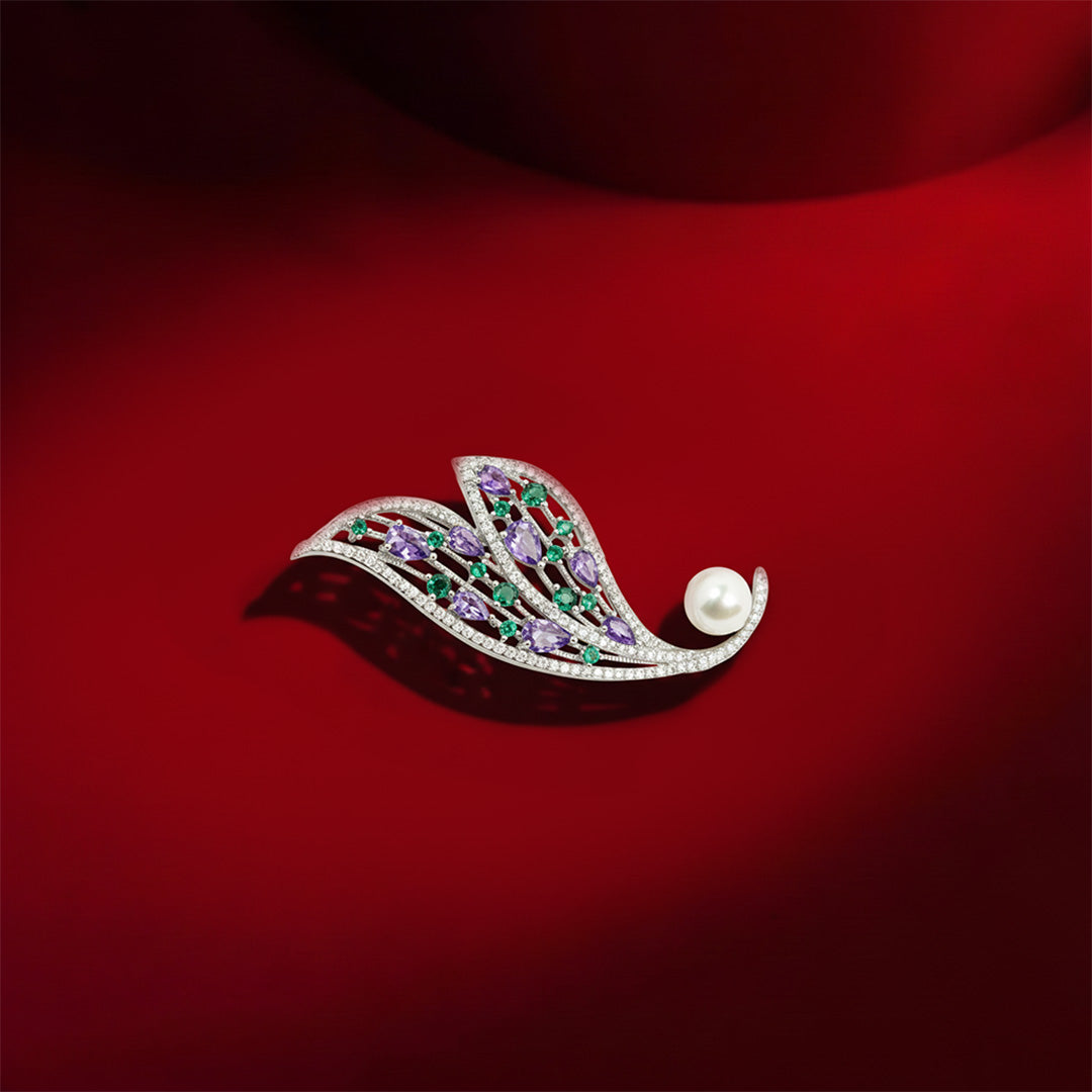Amethyst and Emerald Feather Brooch | Silver Tone Wing Inspired Brooch with Purple Teardrop and Green Round CZ Stones, Full Pave Finish and Pearl Accent | Elegant Festive and Bridal Statement Pin