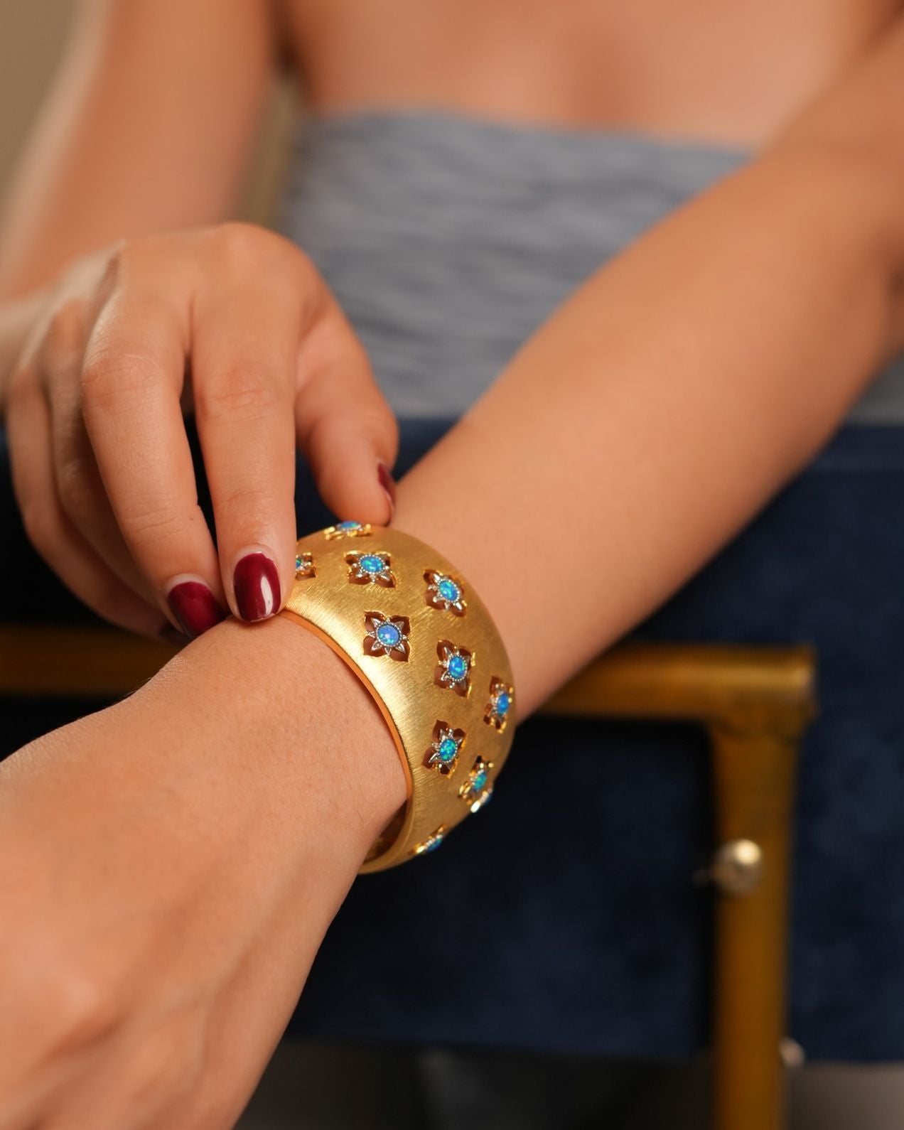 Wide Gold Cuff Bracelet with Intricate Blue Stone Floral Motifs and Satin Finish | Regal Statement Jewelry for Weddings, Festivals, and Special Occasions
