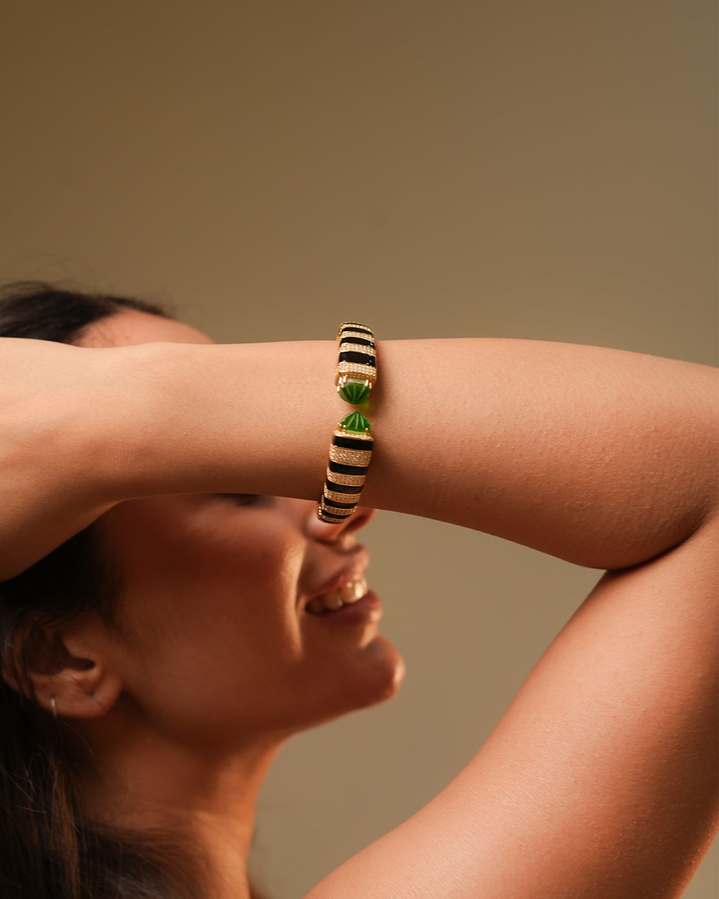 Gold Finish Open Cuff Bracelet with Black Enamel Stripes and Green Gemstone Tips | Luxury Statement Jewelry for Glamorous Occasions