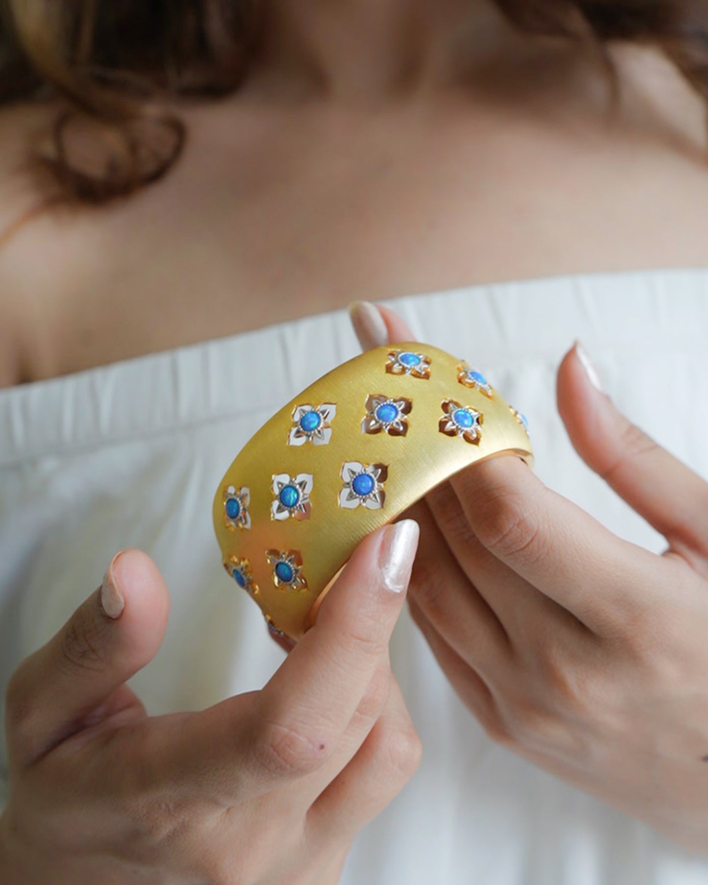 Wide Gold Cuff Bracelet with Intricate Blue Stone Floral Motifs and Satin Finish | Regal Statement Jewelry for Weddings, Festivals, and Special Occasions