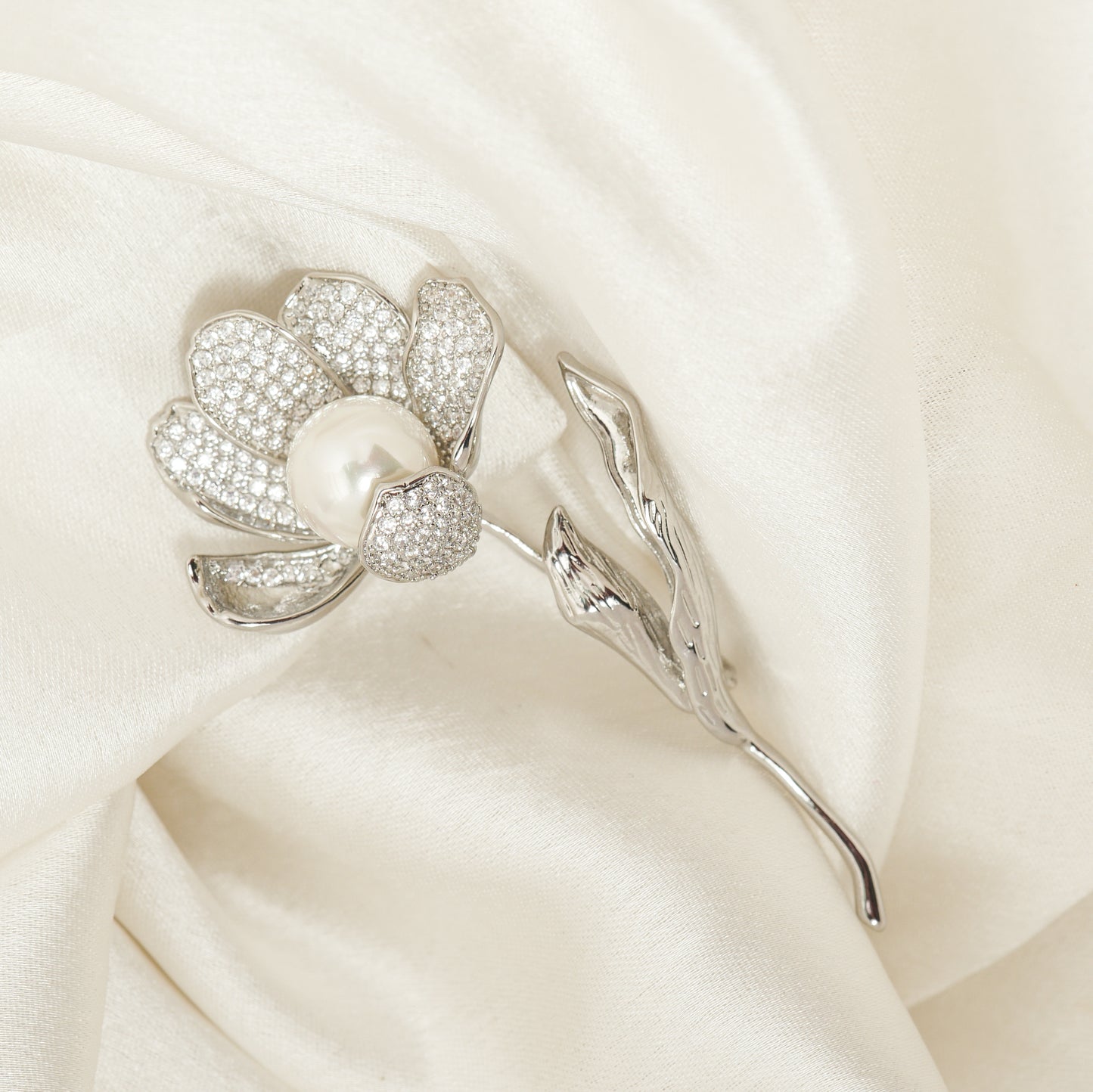 Pave Magnolia Stem Brooch | Silver Tone Floral Brooch with CZ Pave Petals, Textured Leaves and Pearl Center | Elegant Bridal and Festive Statement Pin